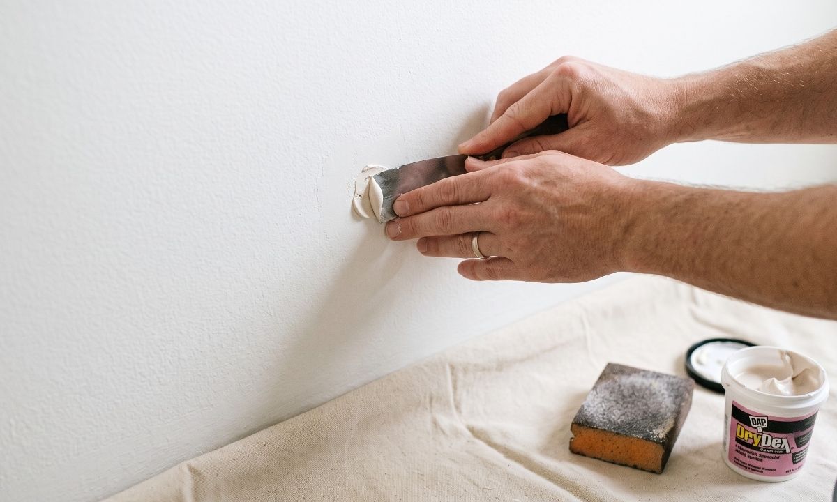Patching nail holes as part of prepping a room before painters arrive